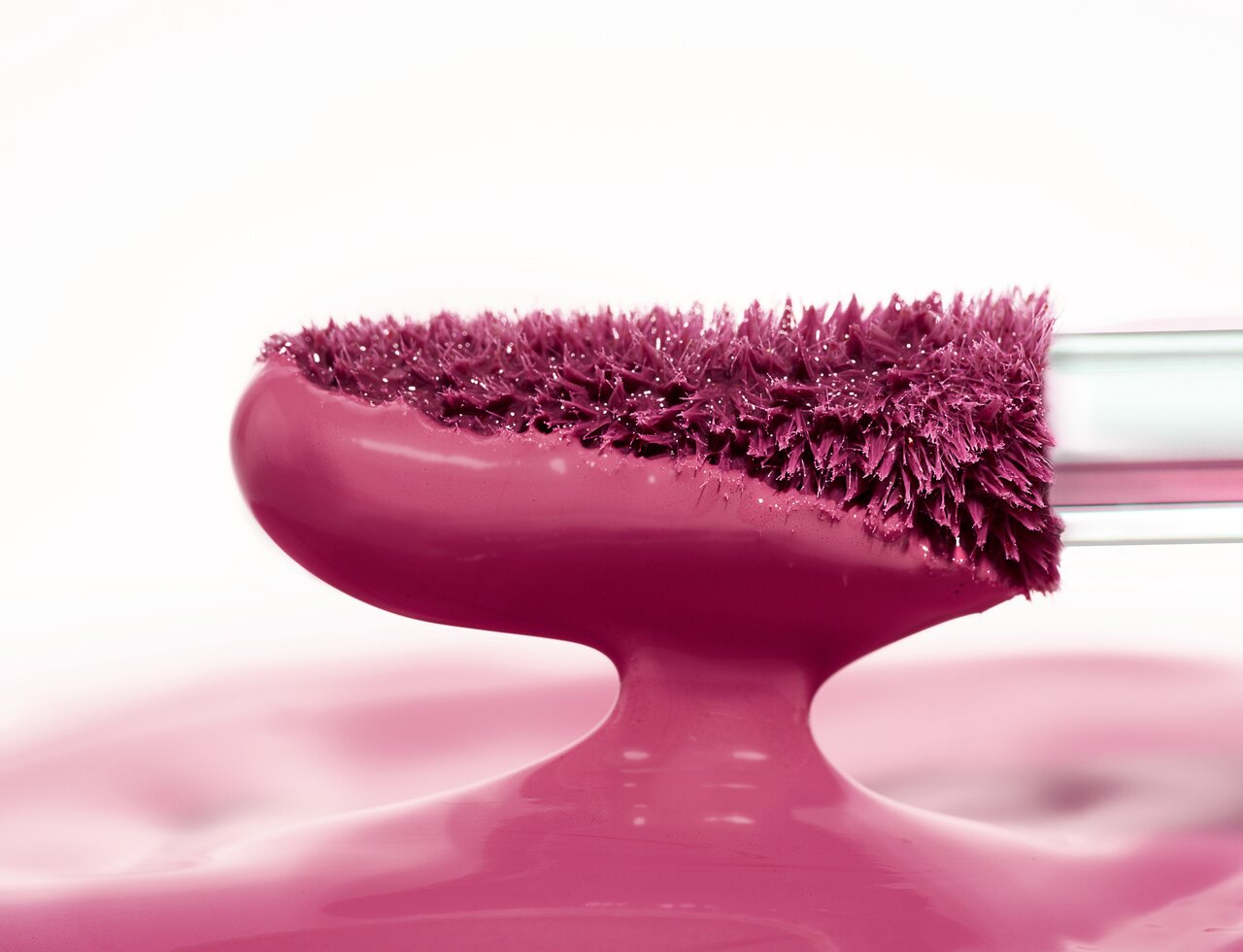 Lipgloss-Applikator, der in den Alcina Matte Liquid Lipstick in dem Farbton Red Grape getupft wird, um die Vielfältigkeit der Lippentrends 2025 und 2026 zu repräsentieren