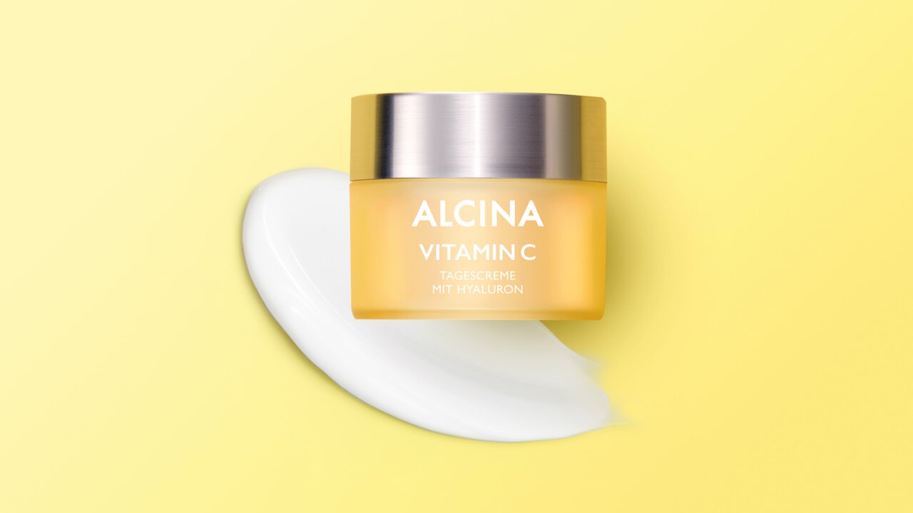 ALCINA Vitamin C Tagespflege Tiegel vor einem ausgestrichenen Cremeklecks